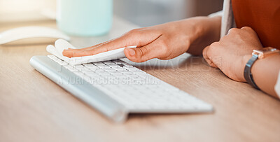 Buy stock photo Clean, office and woman hands cleaning computer keyboard with a wipe for hygiene, cleaniness and disinfection of workspace for bacteria, virus or coronavirus. Closeup of female wiping her office desk