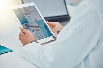 Buy stock photo Doctor using a tablet for research on medical website for medical equipment. Healthcare worker with digital gadget working on web design for clinic. Science, innovation and technology in a modern lab