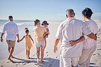 Big family at beach, relax on summer vacation with grandparents and kids at the sea. Big family travel together, quality time in the sun and enjoy a holiday by the ocean. Sand, sunshine and fresh air
