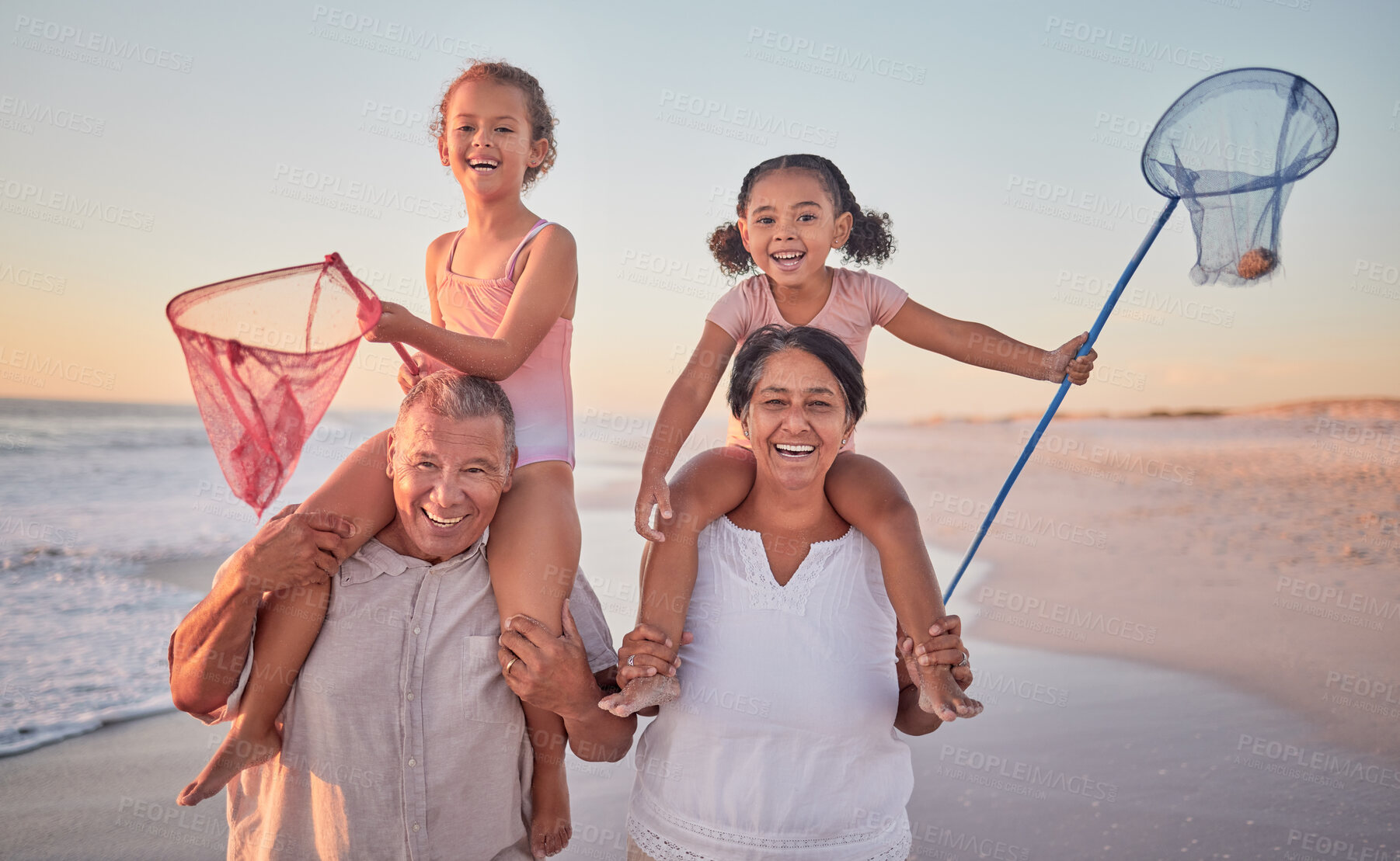 Buy stock photo Children, grandparents and fishing with a family on the beach during summer for holiday, vacation or travel. Kids, happy and ocean with a senior man, woman and their grandkids by the sea at sunset