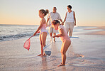 Grandparents and children at the beach with fishing nets and having fun. Young kids and senior couple enjoying holiday with grandkids and retirement together. Swimsuits, ocean and playing by the sea