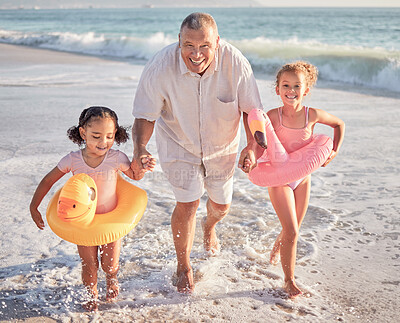 Buy stock photo Children, beach and family with a girl, grandfather and sister playing on the sand by the sea or ocean in summer. Water, travel and fun with a grandparent, grandchild and sibling outdoor on holiday