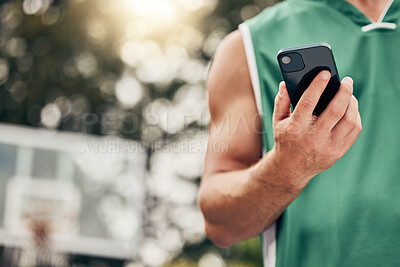 Buy stock photo Man, hands and phone in sports communication and social media for basketball in the nature outdoors. Muscular male in sport fitness, exercise and game time check, message or text on mobile smartphone