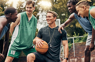 Buy stock photo Basketball coach talking to his team during a training session on outdoor court. Teamwork, motivation and inspiration speech from trainer for basketball team having fun and learning in a sports game