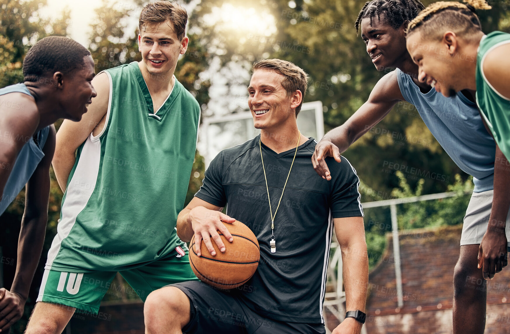 Buy stock photo Basketball coach talking to his team during a training session on outdoor court. Teamwork, motivation and inspiration speech from trainer for basketball team having fun and learning in a sports game