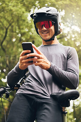 Buy stock photo Cyclist, fitness and phone app for gps, health data and location trail in nature forest, countryside and Australian woods. Smile, happy and motivation sports athlete with bike helmet and mobile tech