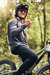 Mountain training, cycling adventure and man doing fitness exercise on nature bike holiday in Mexico with shaka hand sign. Portrait of a professional motorcycle athlete doing cardio in the forest 