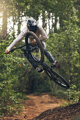 Buy stock photo Sports, adventure and forest with man and mountain biking on park trail for action, freedom and fitness. Jump, speed and fast with athlete training in nature for exercise, health and workout 