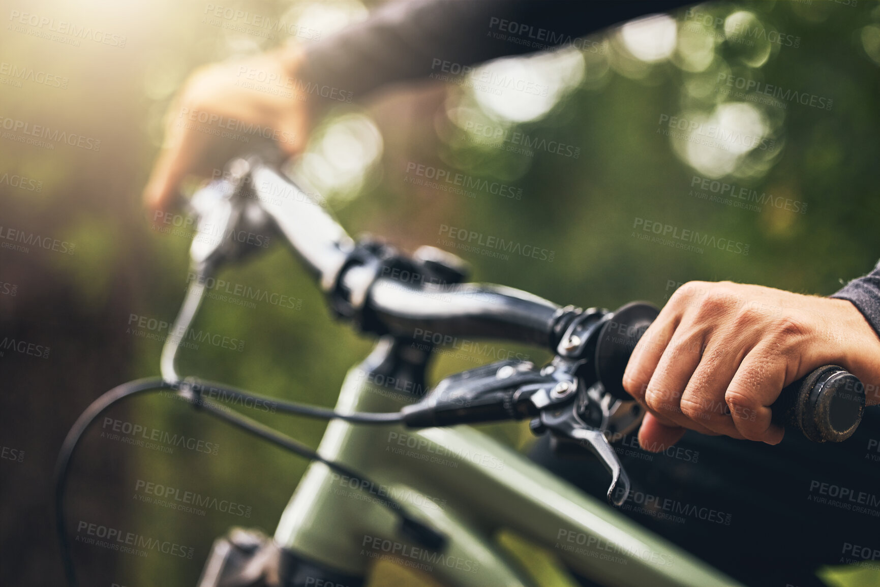 Buy stock photo Forest, mountain biking and trees, hands on handlebar closeup with bokeh. Fitness, health and a man on a bike on outdoor adventure trail. Nature, freedom and exercise, cycling in park on a summer day