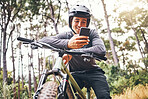Cyclist, phone and bike happy in forest on ride for fitness, health and wellness. Man, smartphone and bicycle on social media or app for communication while in woods for adventure, workout and sport