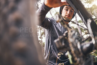 Buy stock photo Cycling, bicycle wheel check and man doing safety maintenance before ride, travel or journey in Ukraine forest. Bike, woods or nature adventure for sports person training for race fitness bottom view