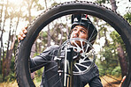 Bicycle, wheel and tyre in forest with man fix problem in zoom or closeup of rim. Cyclist, bike and broken in woods while on training, fitness and travel ride for sport or prepare for competition