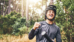 Mountain biking, achievement and celebrate success, win or freedom on bike in forest woods on a cycling adventure in nature. Fitness man on bicycle looking happy on cycling trip with helmet in Norway