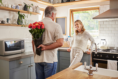 Buy stock photo Senior, couple and flowers for love in kitchen, husband with bouquet of roses to wow wife, happy and marriage on wedding anniversary. Man, flowers and woman together, romance and surprise in home