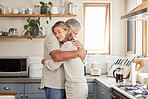 Hug and support of a retirement couple in a home kitchen  with love, care and mental health. Trust, help and embrace of marriage or pension people, comforting senior partner together in their house