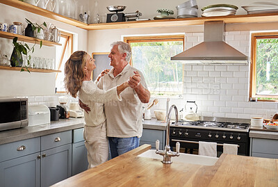 Buy stock photo Dance, couple and kitchen with a senior man and woman dancing together in a retirement home. Love, freedom and romance with an elderly male and female pensioner having fun in a house in the morning