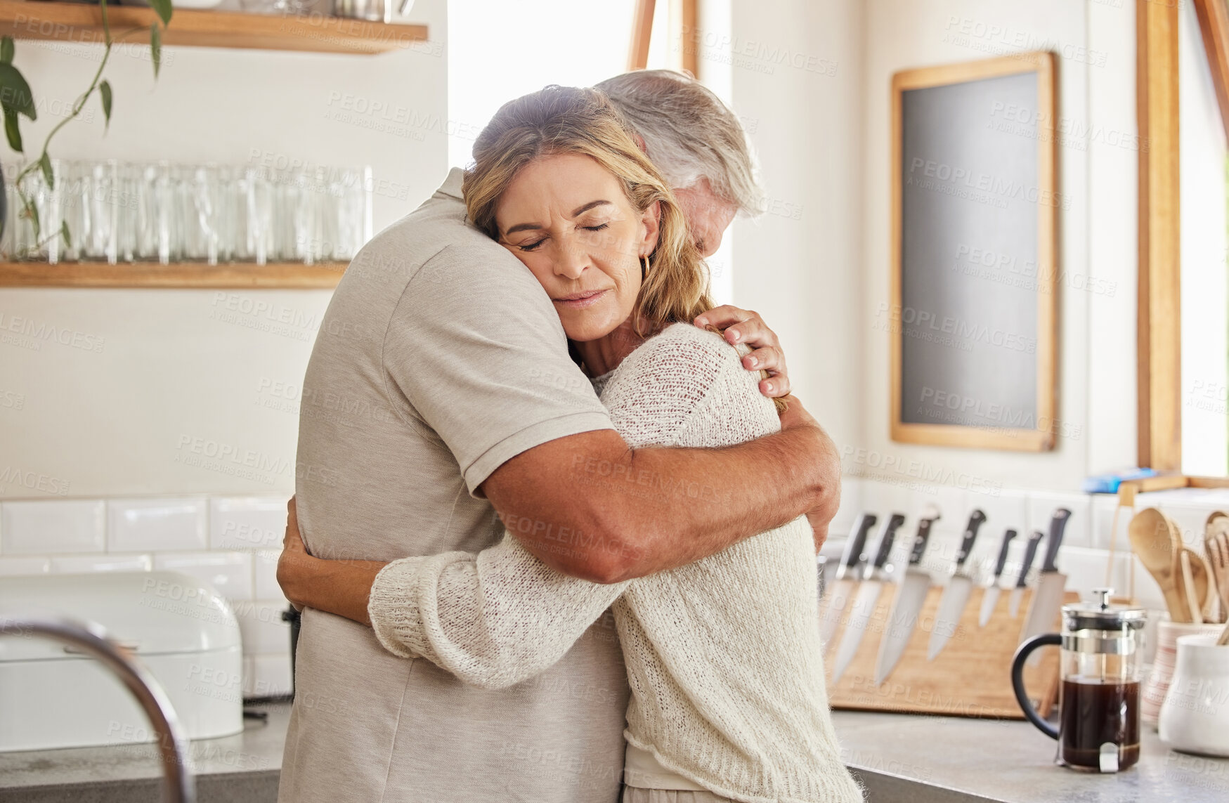 Buy stock photo Couple, elderly and hug in kitchen in home together, romance and love. Care, man and woman in retirement love, marriage and embrace in sad moment for support, comfort and unity as married people