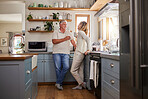 Relax, coffee and elderly couple in a kitchen, bonding and talking in their home together. Love, woman and mature man enjoying retirement and relationship indoors, casual conversation in the morning