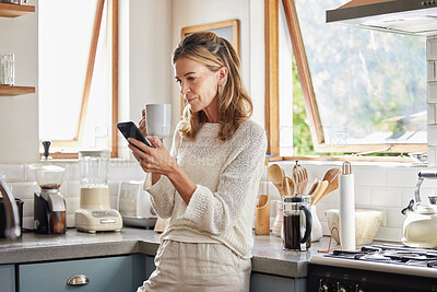 Buy stock photo Coffee, phone and senior woman in kitchen browsing social media, text message or online app at home. Relax, tea and reading news or mobile online web surfing with female from Canada on 5g smartphone
