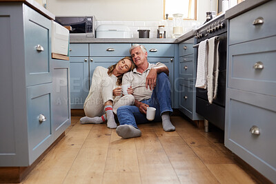 Buy stock photo Coffee breakfast, relax and senior couple with smile on the kitchen floor in the morning in their house. Calm elderly man and woman in retirement talking with tea and love in marriage in home