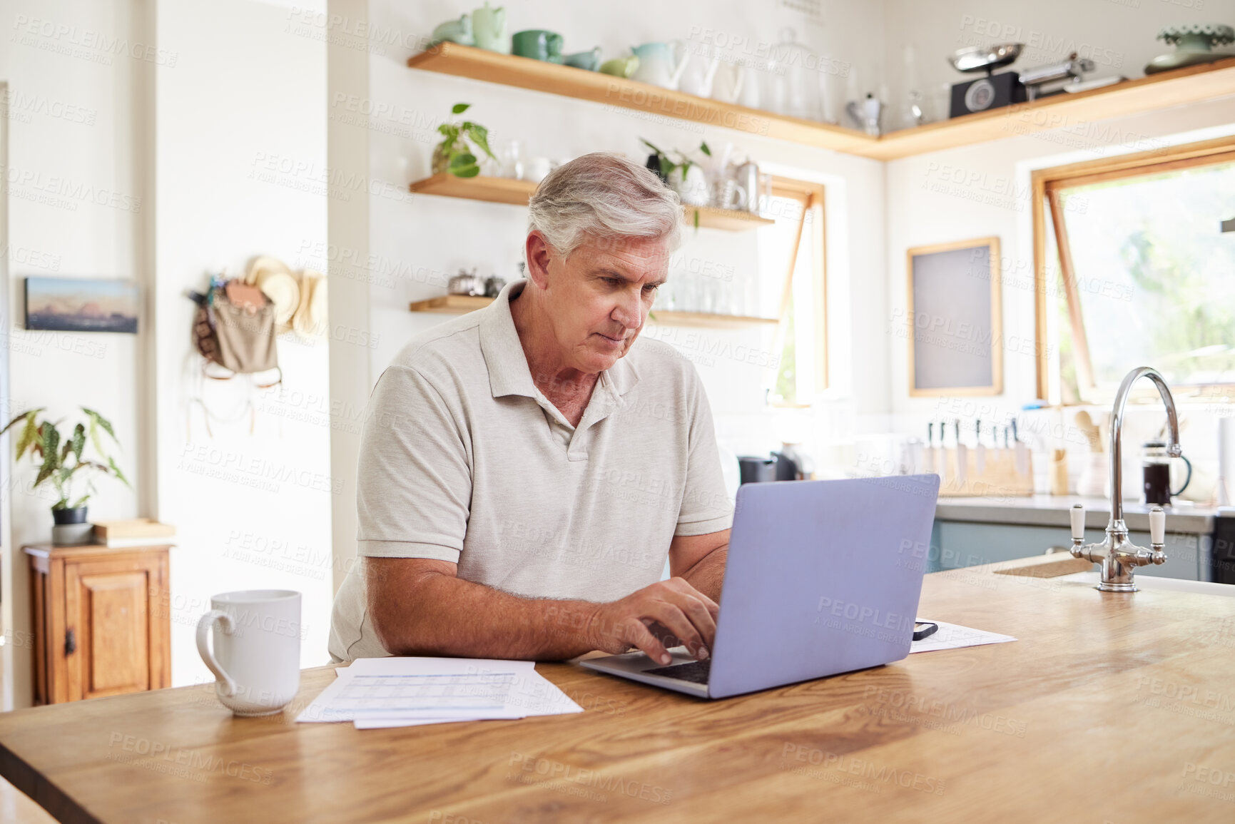 Buy stock photo Senior man, laptop and working in kitchen on retirement plan, budget and expenses at home. Elderly male typing on computer in Australia, planning finances, checking or sending email on technology