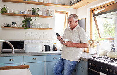 Buy stock photo Coffee, phone and elderly man in kitchen texting and reading news or social media in his home. Happy, communication and 5g network with senior male enjoying fast internet and online app conversation