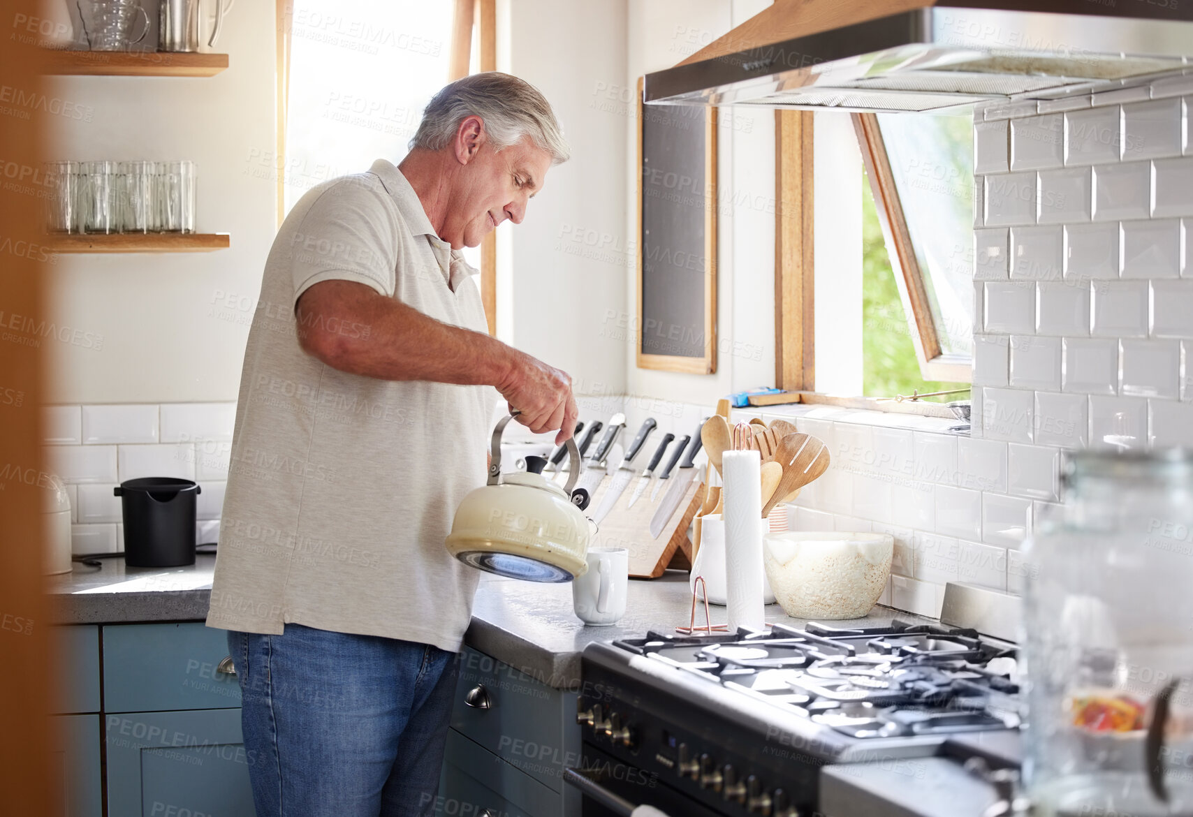 Buy stock photo Retirement man and kettle for tea in kitchen preparation for leisure drink in New Zealand home. Senior, healthy and mature guy enjoying pension lifestyle relaxing in house with a cup of coffee