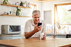 Phone, kitchen and senior relax man doing internet, web or online search for meme, funny video or comedy. Retirement life, mobile and elderly person with coffee, tea and typing on social media app