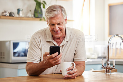 Buy stock photo Mature man reading phone, social media notification and mobile app news in New Zealand kitchen home. Happy male drinking coffee, typing online smartphone and 5g wifi technology connection in house