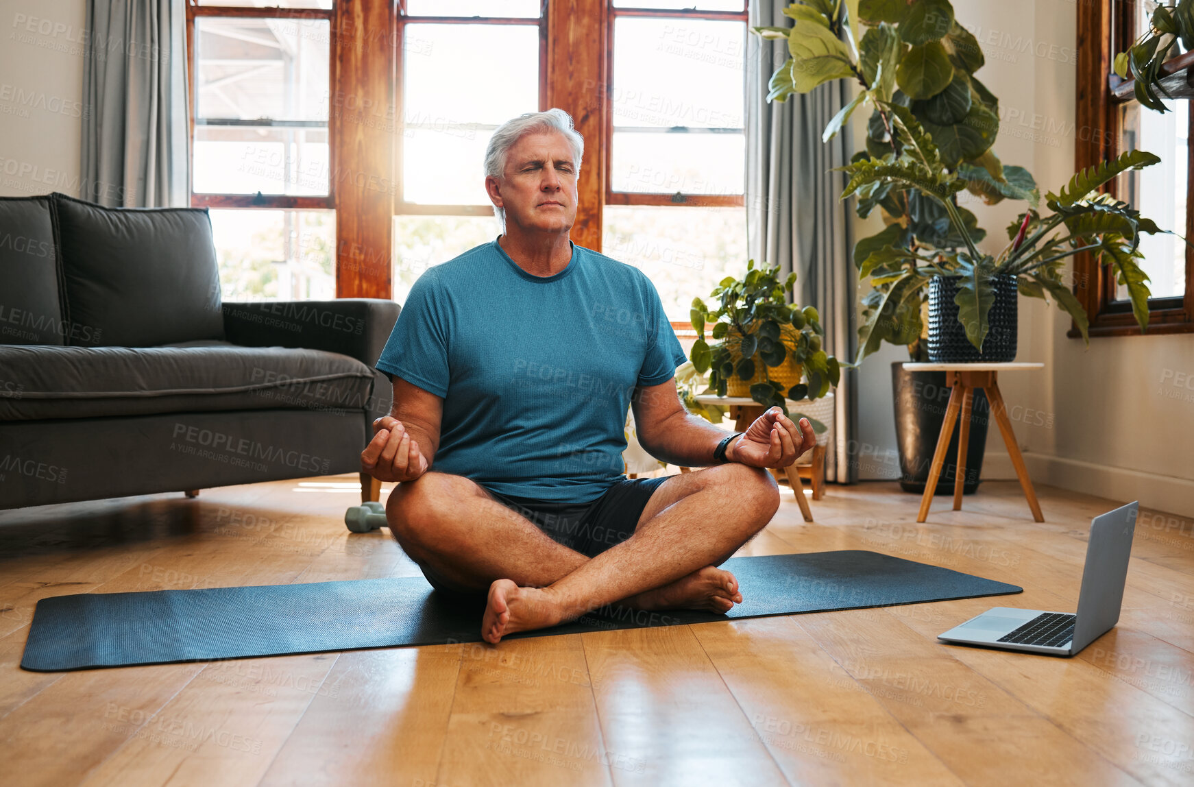 Buy stock photo Yoga, online and meditation with a senior man following a zen fitness class for workout, exercise and training. Laptop, health and retirement with an elderly male pensioner exercising in his home