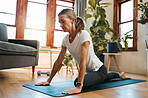 Woman, yoga and pigeon pose stretching in house or home living room for relax exercise, training and workout in Germany lockdown. Zen, calm and mature peace yogi in mind wellness and fitness for hips