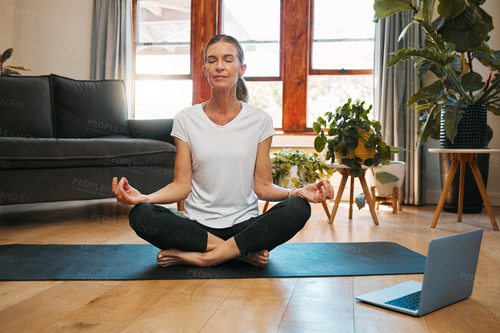 Buy stock photo Meditation, laptop and elderly woman learning zen workout online tutorial in living room, happy and content. Fitness, peace and yoga for beginner by senior female enjoy retirement healthy activity