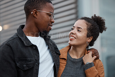 Buy stock photo Couple, love and diversity with a man and woman outdoor walking together in an urban city during the day. Dating, relationship and romance with a young male and female outside in town with a smile