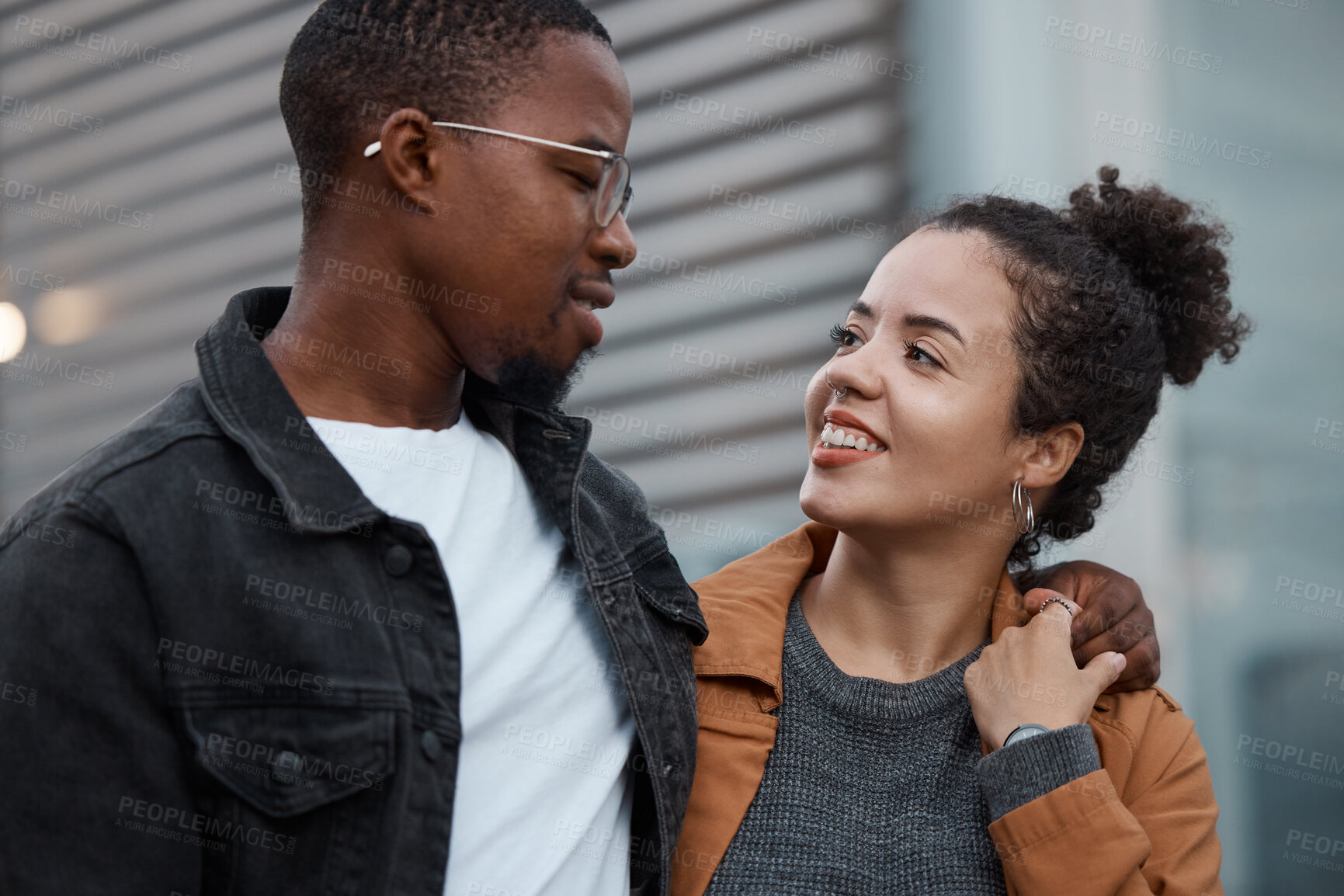 Buy stock photo Couple, love and diversity with a man and woman outdoor walking together in an urban city during the day. Dating, relationship and romance with a young male and female outside in town with a smile