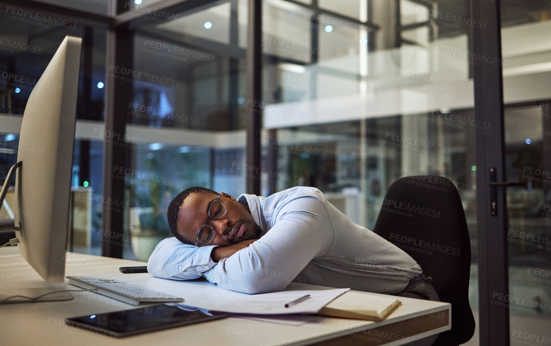 Buy stock photo Night business, work sleep and businessman sleeping at desk with computer in dark office at a corporate company. Tired African manager or employee with burnout taking a nap while working overtime