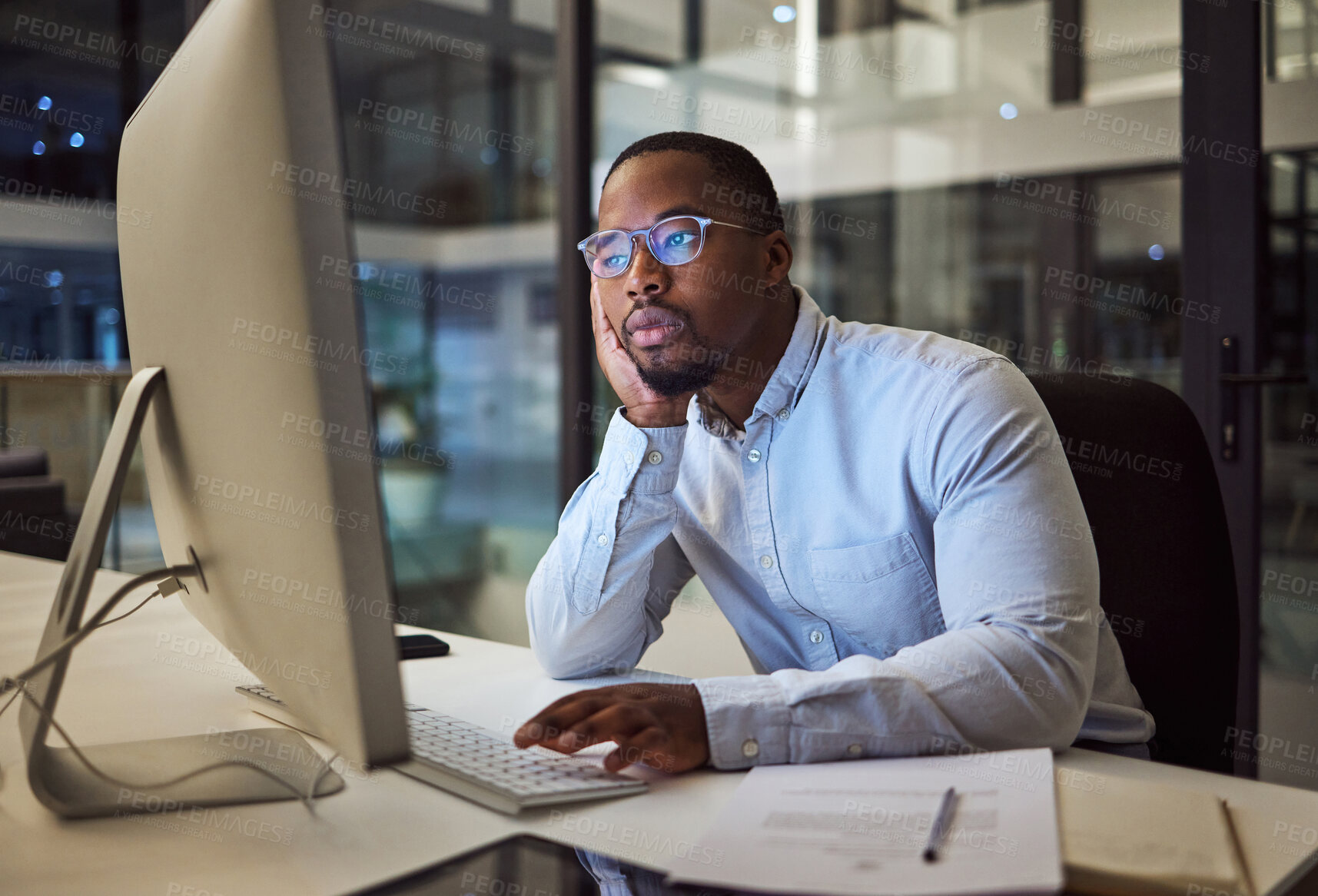 Buy stock photo Tired, burnout businessman on computer at night in a dark office working on company finance management. Sad, mental health and depression corporate accountant with glasses and tax or audit paperwork