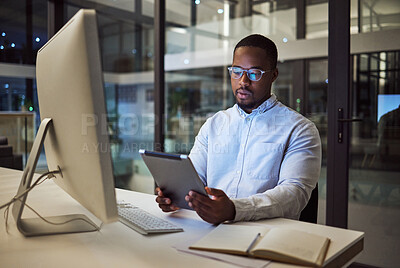 Buy stock photo Black businessman, tablet planning and desktop at night in startup for online ideas, strategy and connect apps on 5g technology in Nigeria. Employee working in dark modern office for internet project