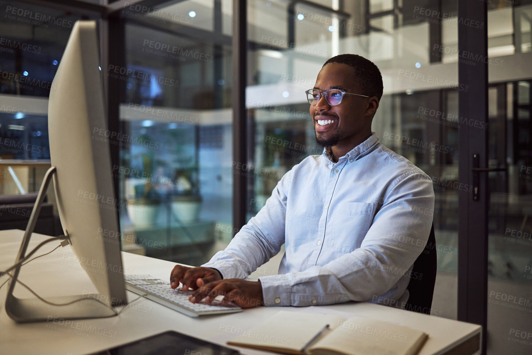 Buy stock photo Computer, african businessman and working at night typing on keyboard for corporate research in office. Professional, happy and black man planning a management review for employee with technology