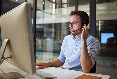 Buy stock photo Telemarketing, man and employee in call center with headphones at desk. Worker or consultant at table on computer talking to client, checking information or consulting customer with technical support