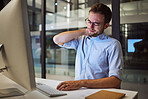 Burnout, neck pain and tired with an exhausted businessman working on a computer in his office late at night.  Stress, headache and problem with a male employee at work on a project deadline