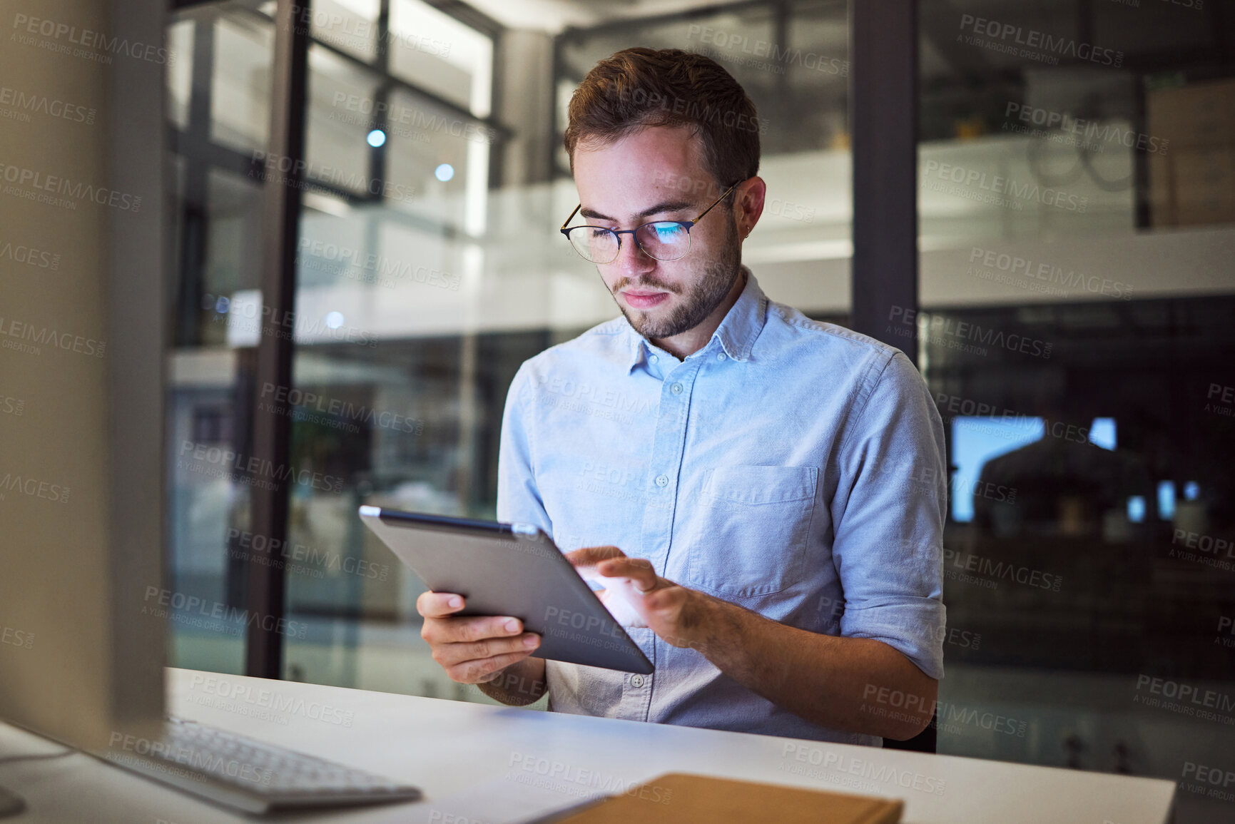 Buy stock photo Tablet planning, night research and businessman working on the internet in a dark office at work. Business employee reading an email on the web with technology during overtime at a corporate company