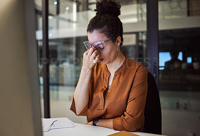 Buy stock photo Stress, burnout and woman with a headache tired from working overtime at her office desk due to paperwork deadlines. fatigue, mental health and overwhelmed administrator frustrated with a migraine 