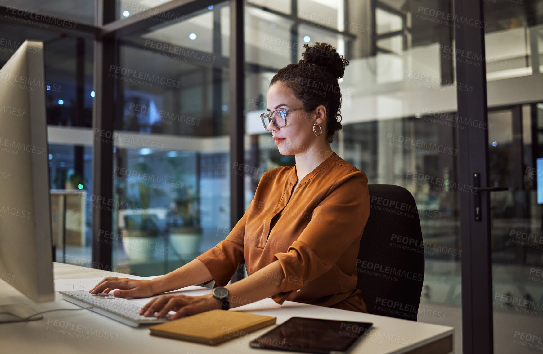 Buy stock photo Night, office and woman on computer working on a social media business marketing and advertising project. Desk table, workplace and online brand expert typing on pc and work on a web promotion design