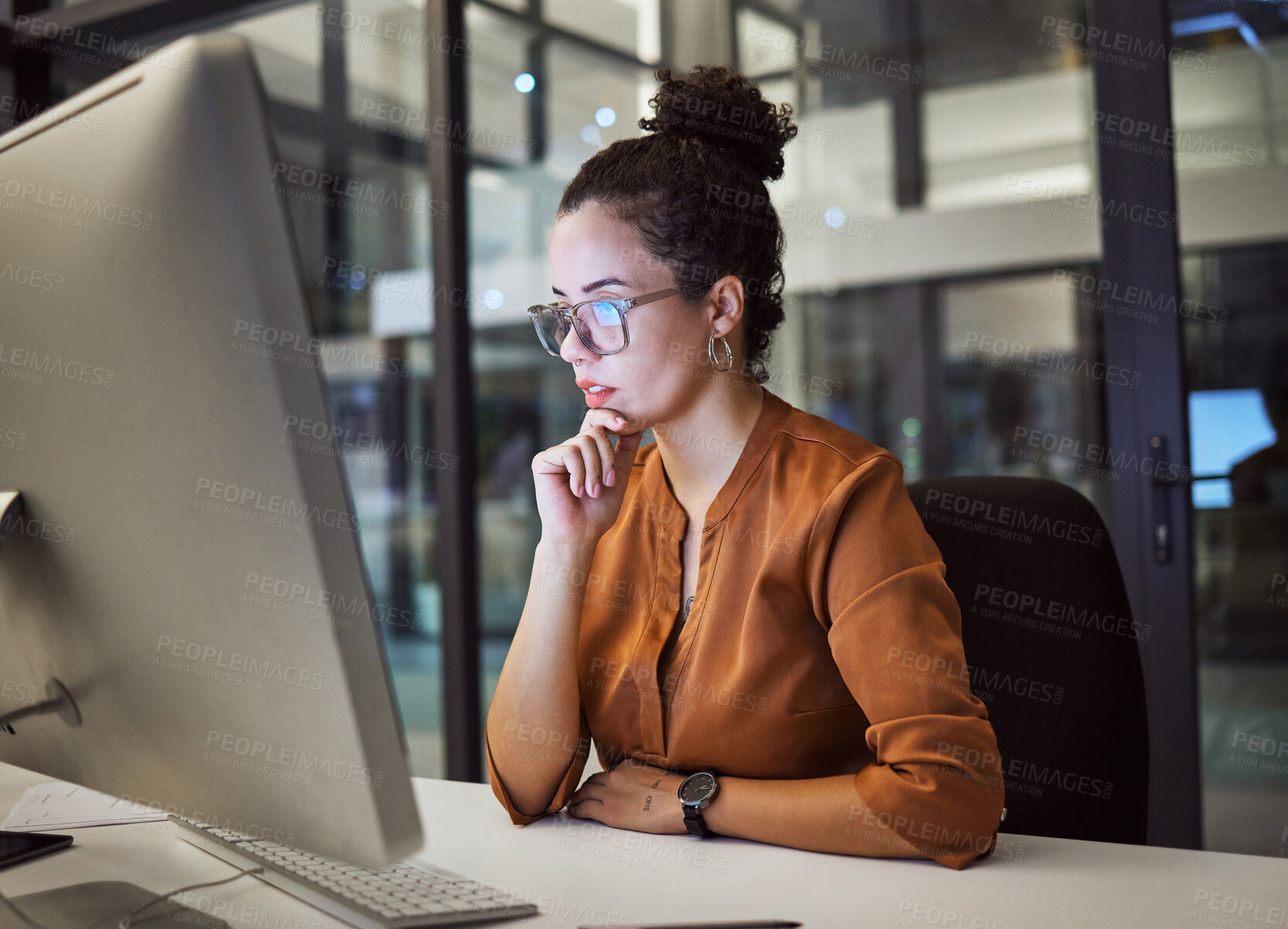 Buy stock photo Woman, computer and office with glasses show reflection on face while working overtime. Girl, thinking and idea read analytics, email or communication online at work late at business in the night