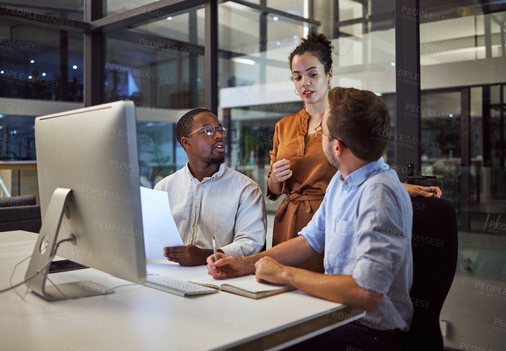 Buy stock photo Marketing team in office, working at night on advertising and business strategy. Group meeting by desk, discuss collaboration and teamwork on company report. Teamwork, leadership and career success 
