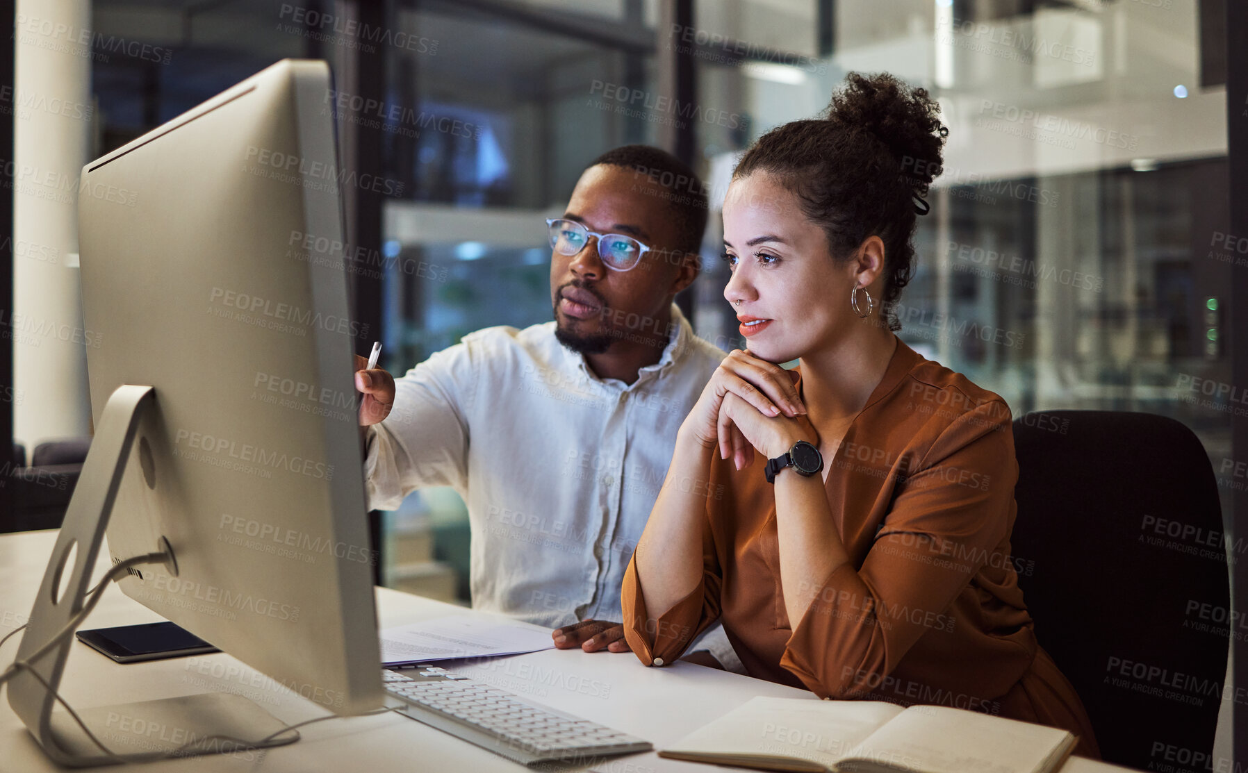 Buy stock photo Business training, night planning and employees talking about corporate proposal on internet in dark office at night. African workers working on partnership on the web with computer during overtime