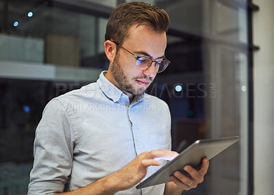 Buy stock photo Man in the office, at night with digital tablet and working overtime. Professional business man in online marketing company, planning corporate strategy and testing new web feature to increase growth