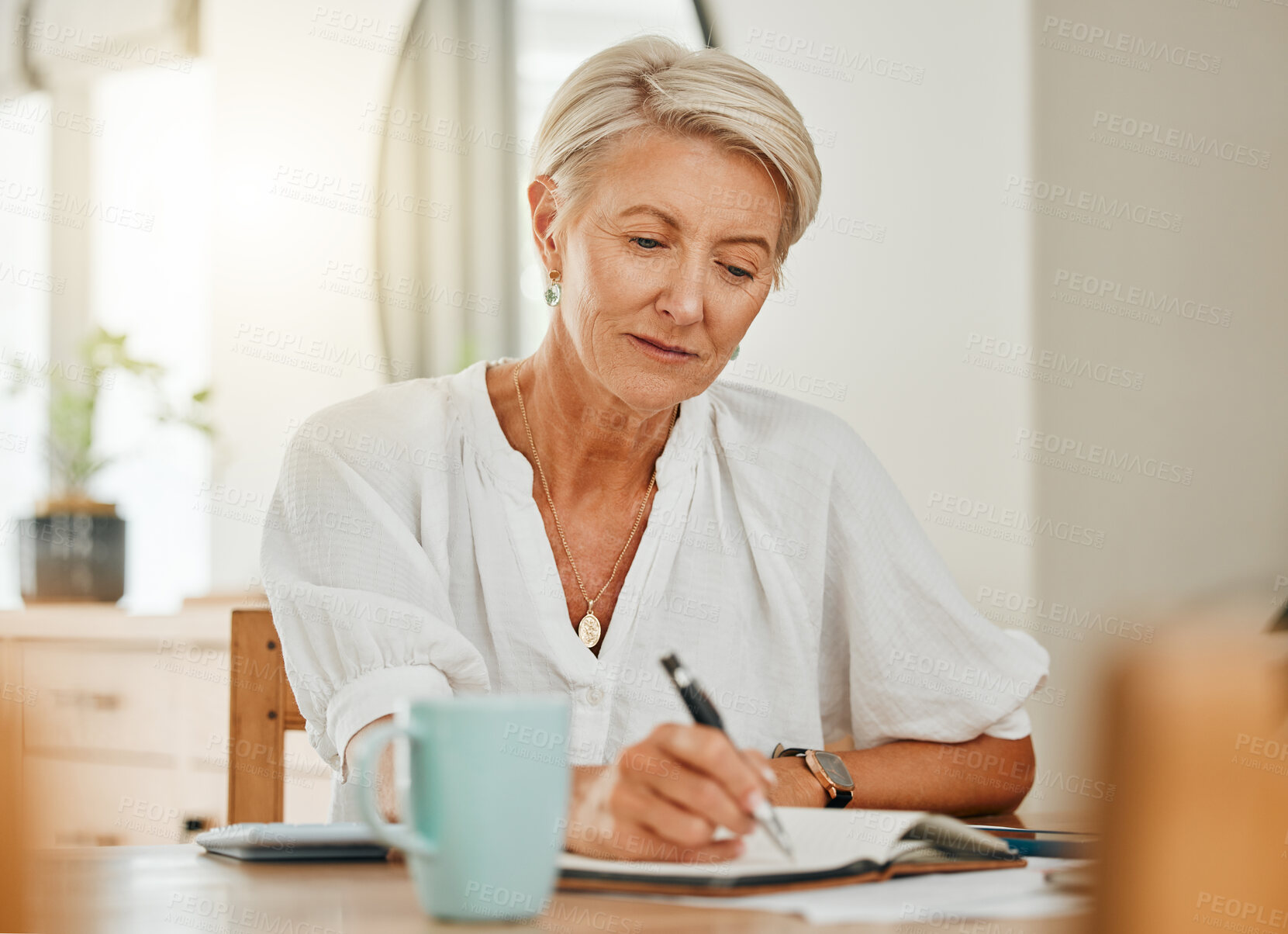 Buy stock photo Writing, thinking and senior woman at a house making notes on notebook paper. Retirement of a serious person from Sweden think about schedule, day agenda idea or document and write ideas at home