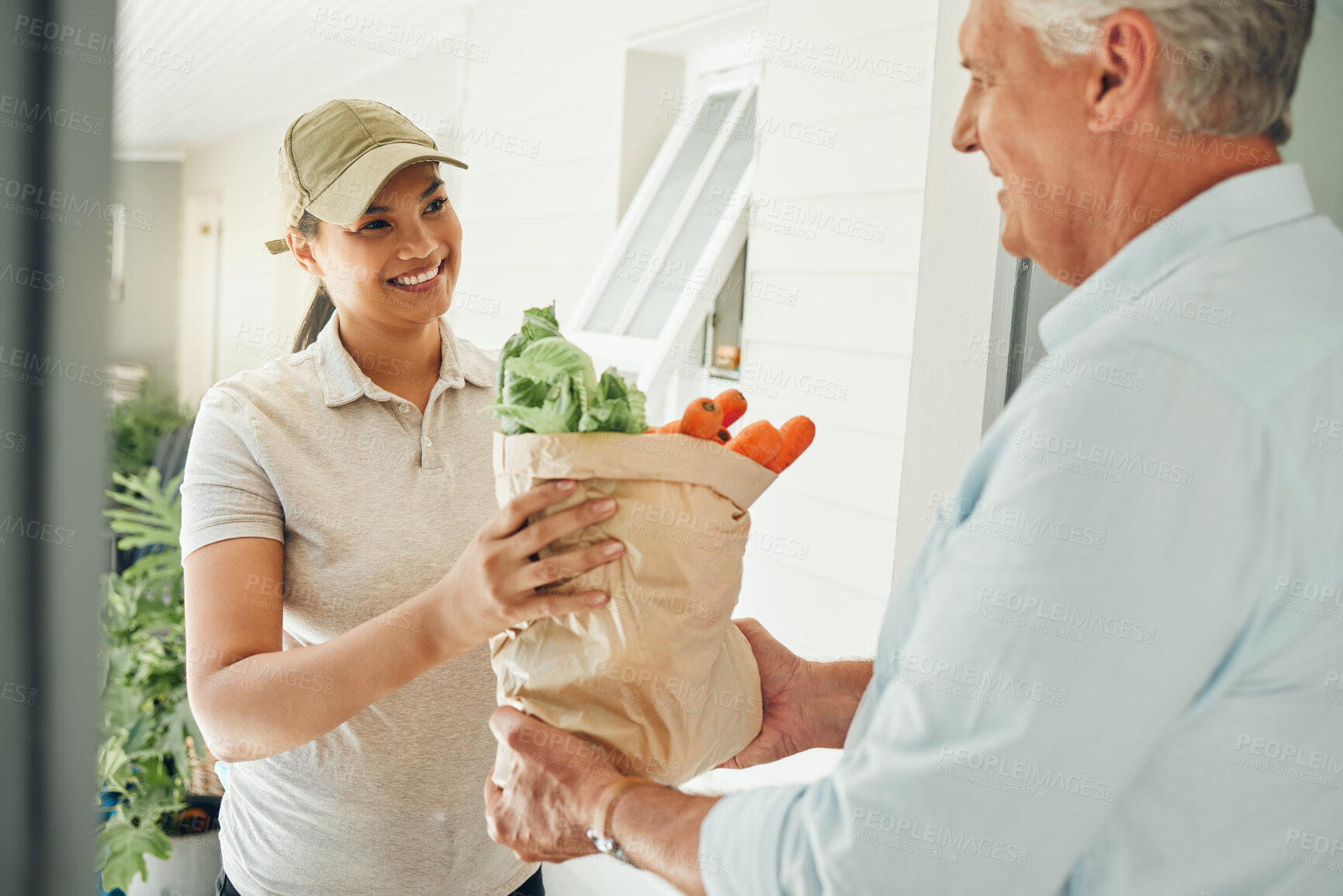 Buy stock photo Home delivery service, fresh vegetables and customer paper bag logistics of healthy groceries at front door house. Happy woman courier giving organic grocery shopping package to senior consumer man