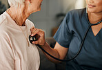 Cardiology consultation, doctor and senior woman consulting about healthcare on living room sofa in retirement home. Hand of nurse with stethoscope while helping elderly patient with medical service